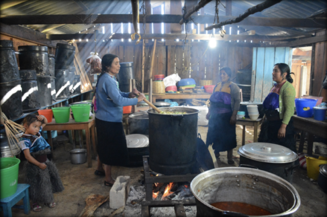 Three Tzotzil women and a little girl preparing a meal for over 100 persons at a public forum organized by Luz y Fuerza del Pueblo - La Candelaria, San Cristóbal de las Casas, Chiapas. December 2016.