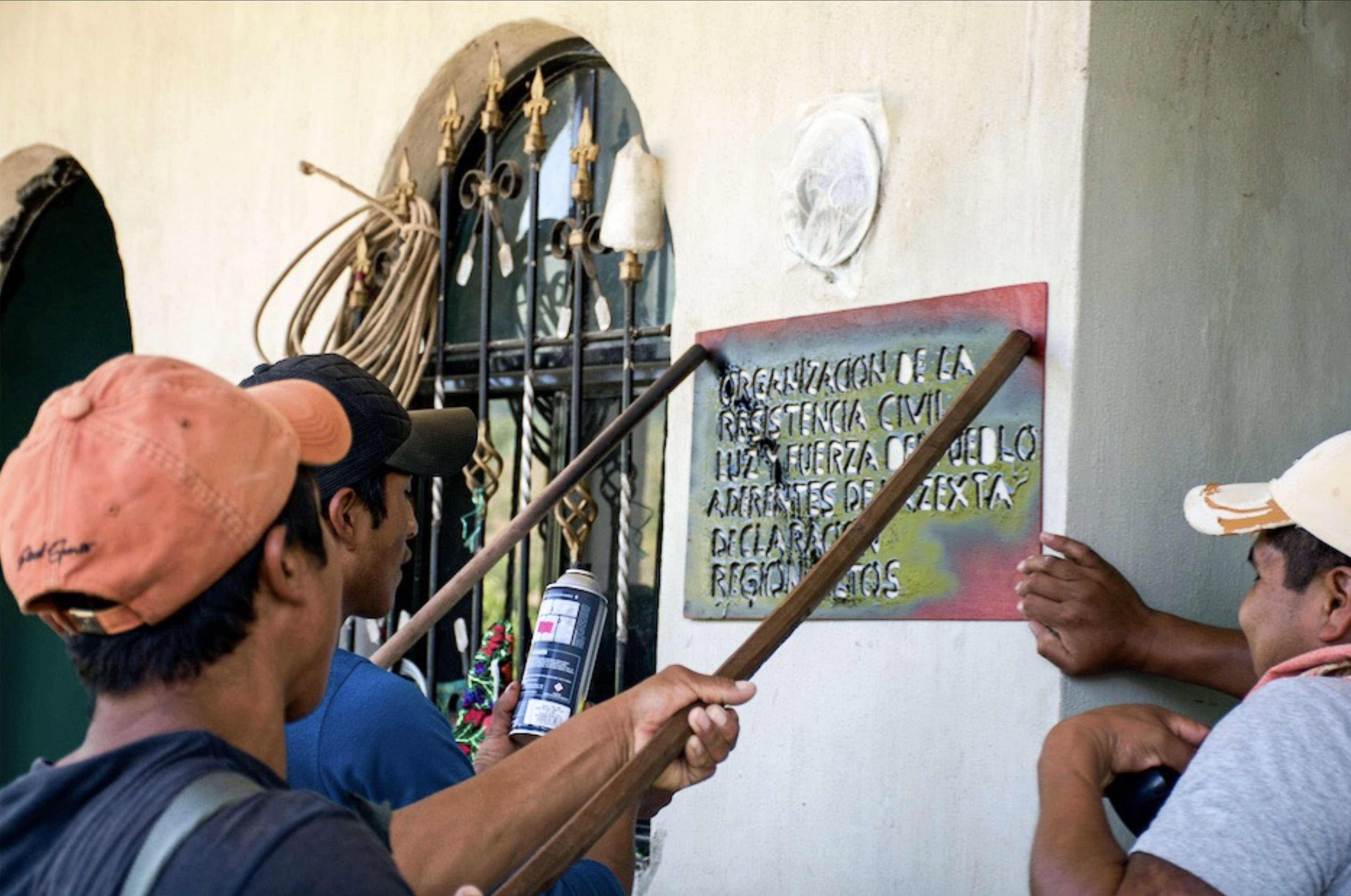 Three compañeros marking the house of a new activist with the Luz y Fuerza del Pueblo seal - Taniperla, Chiapas. March 2017.